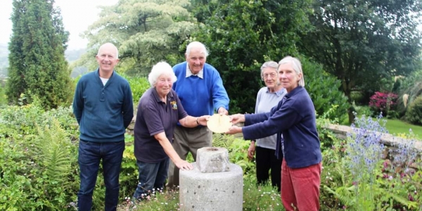 Burrow Farm Gardens being awarded a sundial to celebrate being an NGS garden for 40 years