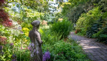 Statue-in-naturalistic-planting-at-Burrow-Farm-Gardens Beautiful Old Statue overlooks path surrounded by naturalistic planting